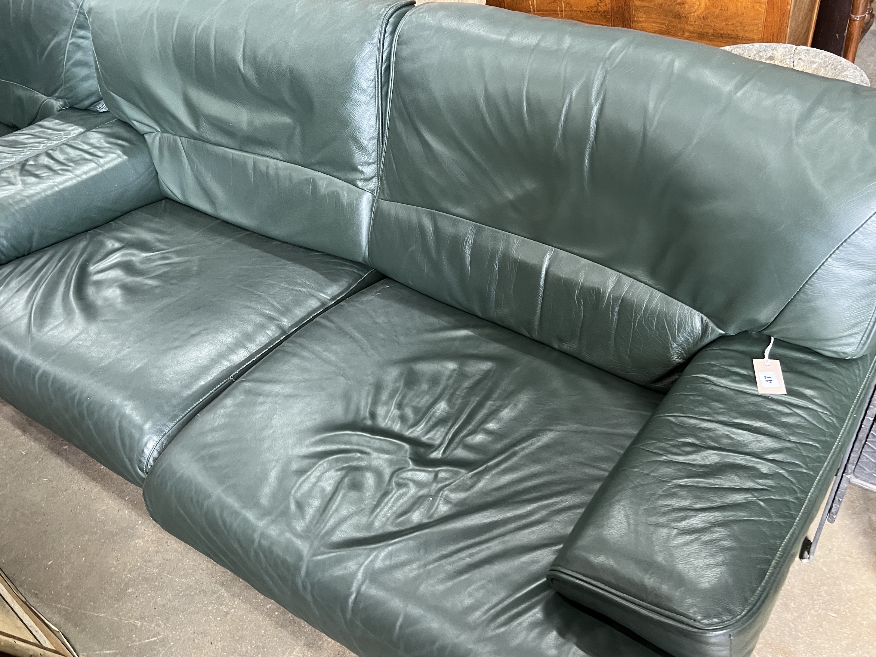 A pair of Army and Navy dark green leather upholstered settees, length 190cm, depth 80cm, height 84cm